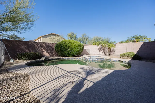a swimming pool with outdoor seating and yard