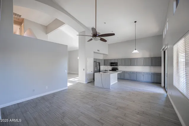 a view of a kitchen with a sink and microwave
