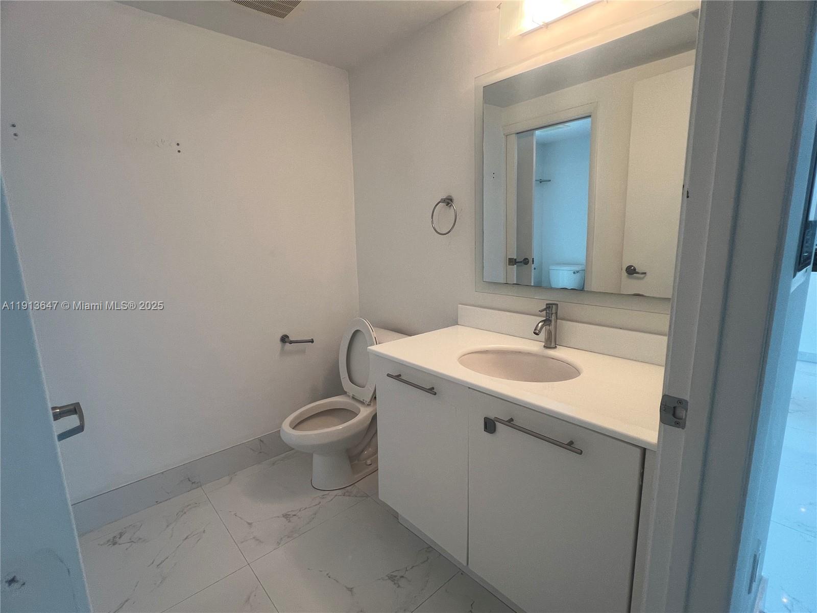 92 Southwest 3rd Street, Unit 3803 Miami, FL 33130 - Photo 18 of 27 a bathroom with a sink toilet and mirror