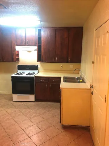 a kitchen with stainless steel appliances a cabinets and a stove top oven