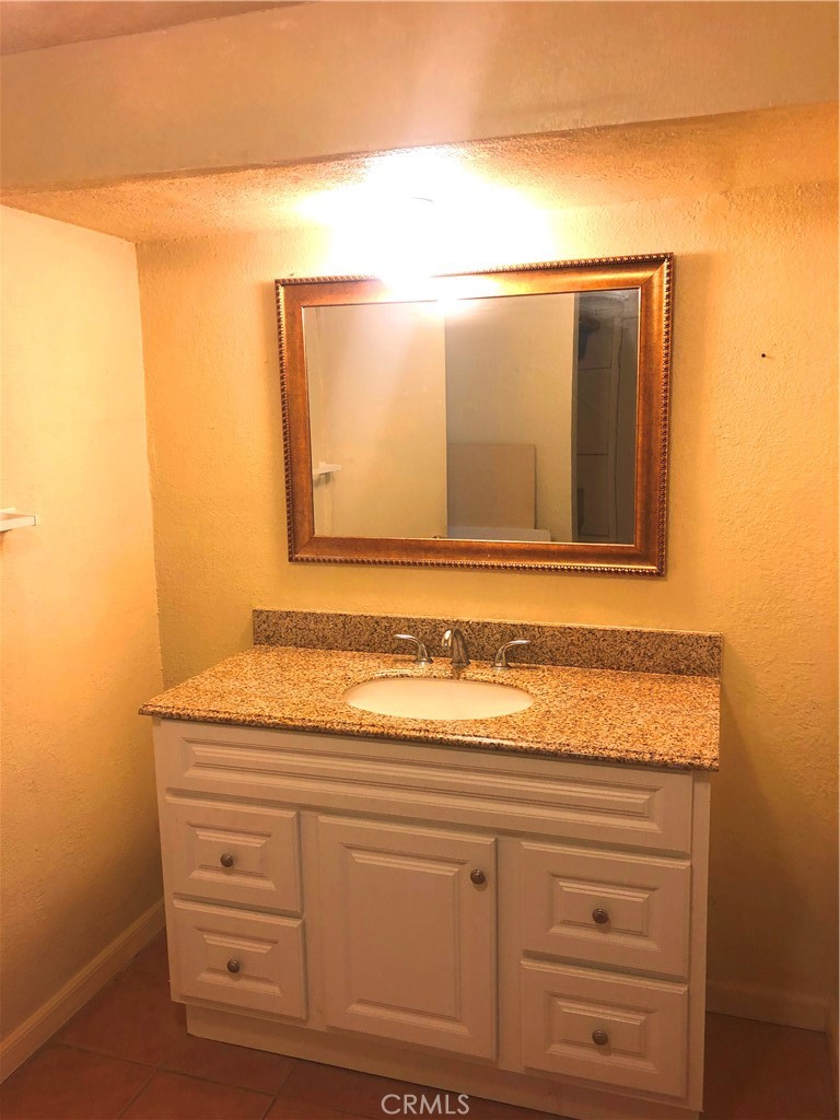 14650 Boyle Avenue Fontana, CA 92337 - Photo 8 of 15 a bathroom with a sink and a mirror
