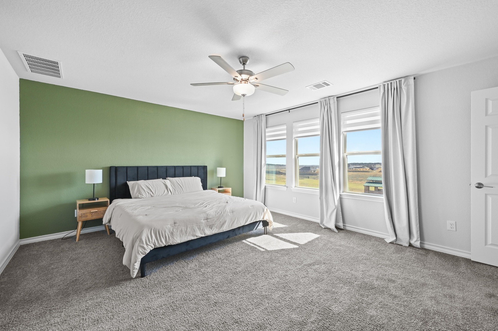 116 Small Seed Drive Buda, TX 78610 - Photo 16 of 40 Bedroom featuring a ceiling fan, carpet, and a textured ceiling
