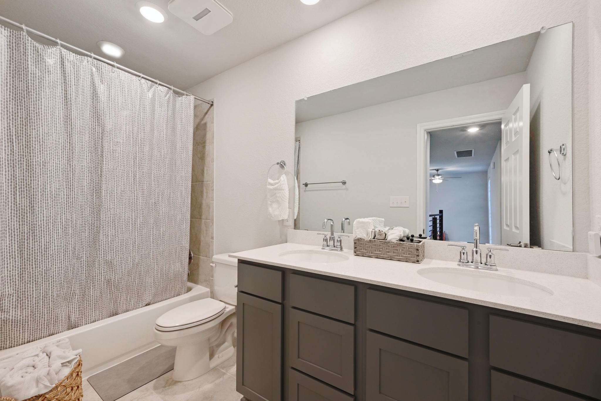 116 Small Seed Drive Buda, TX 78610 - Photo 23 of 40 Full bathroom with double vanity, shower / bathtub combination with curtain, recessed lighting, and ceiling fan