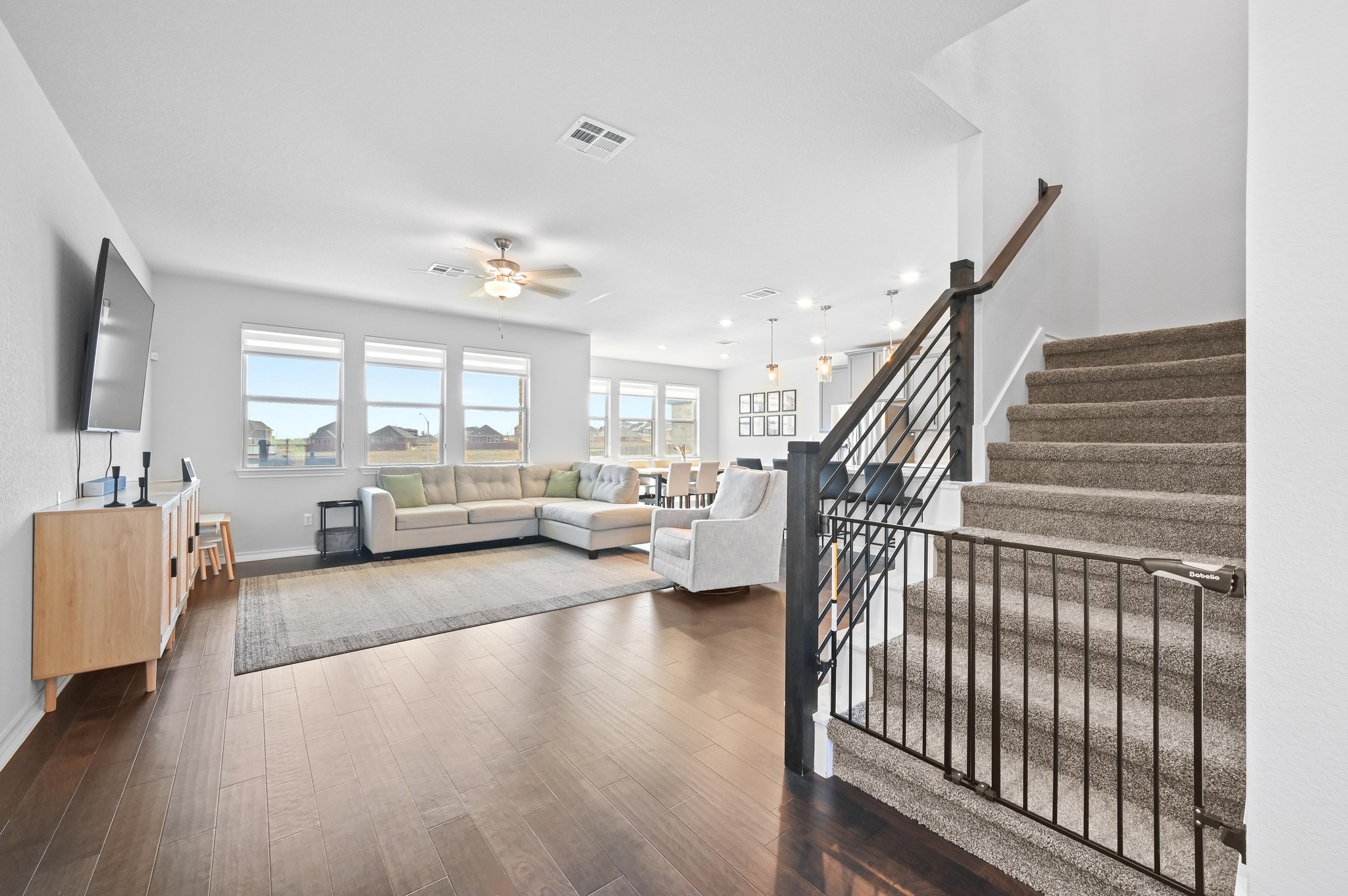116 Small Seed Drive Buda, TX 78610 - Photo 4 of 40 Living area featuring dark wood-style floors and a ceiling fan