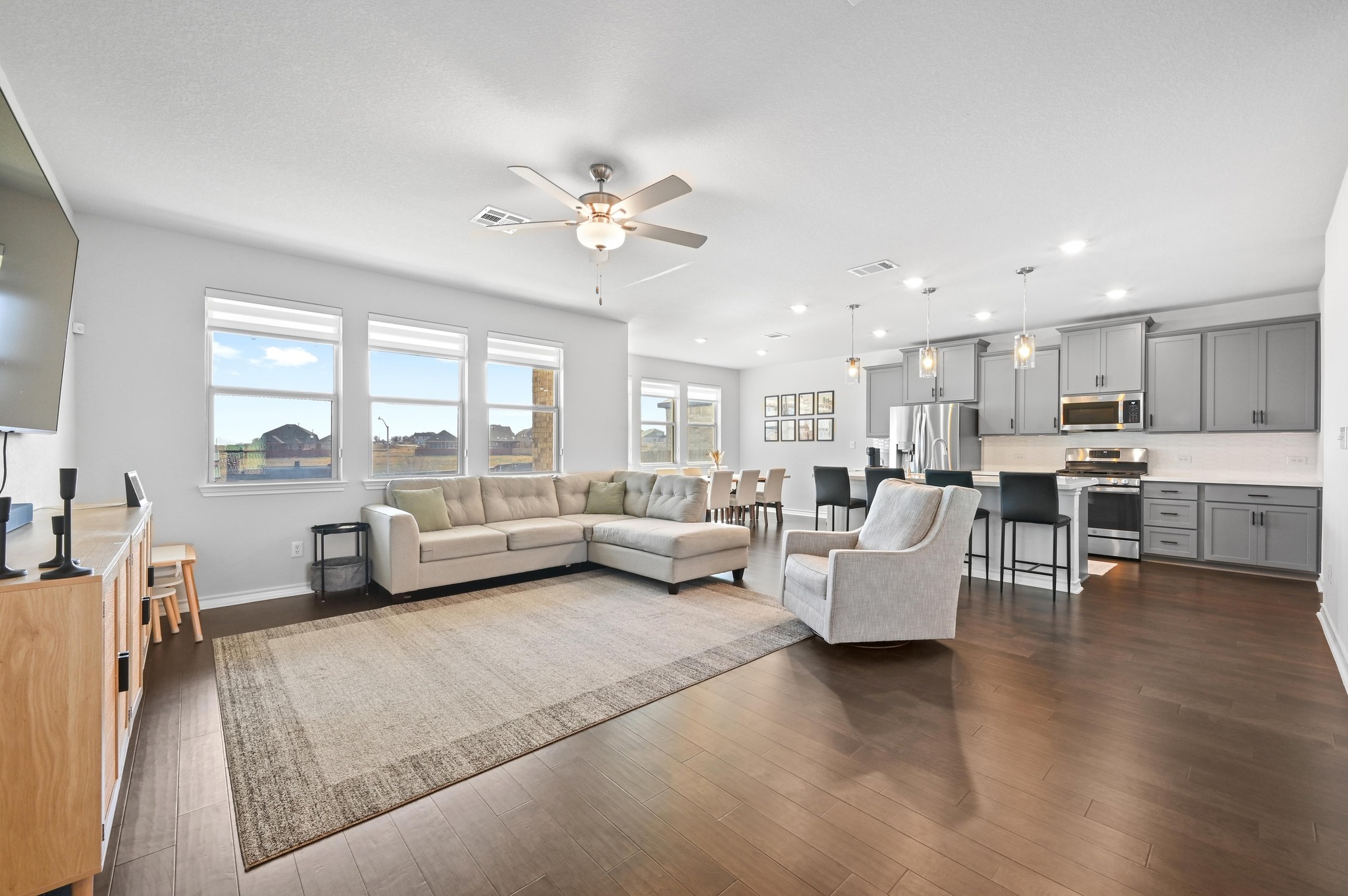 116 Small Seed Drive Buda, TX 78610 - Photo 5 of 40 Living room with a ceiling fan, dark wood-type flooring, healthy amount of natural light, and recessed lighting