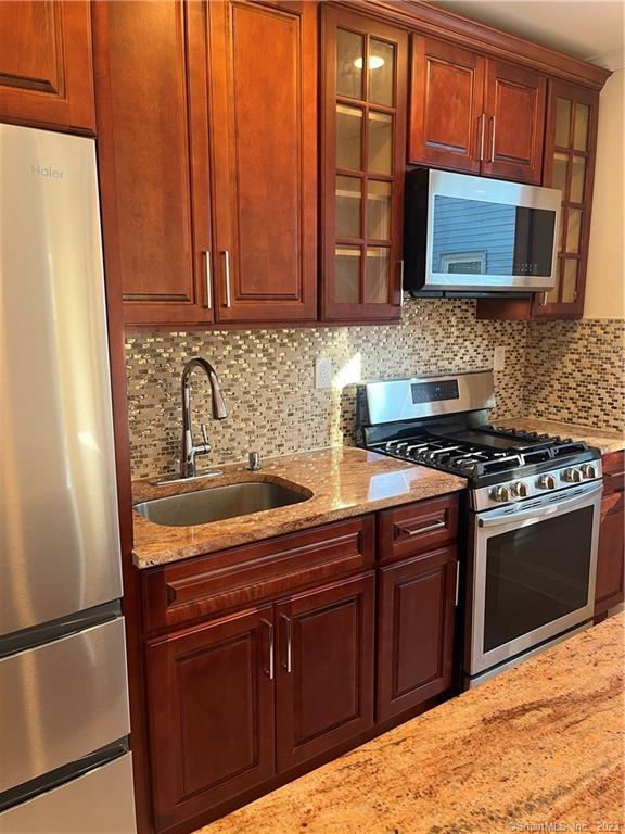 192 Alder Street, Unit 3 Waterbury, CT 06708 - Photo 1 of 1 a kitchen with stainless steel appliances granite countertop a stove microwave and sink