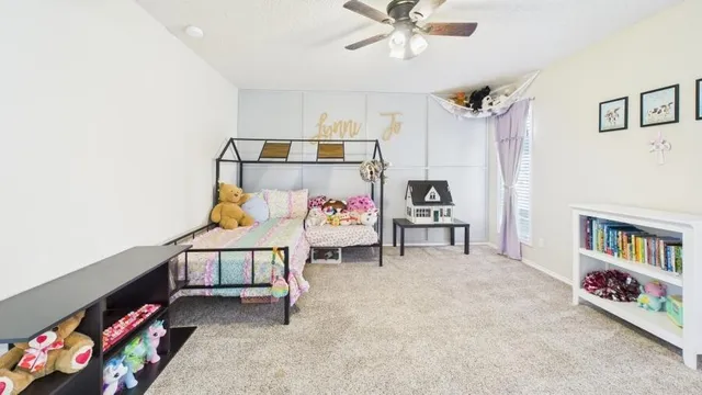 a bedroom with furniture and a book shelf