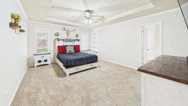a living room with a bed and a chandelier