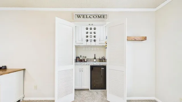 a view of a hallway with a dining table and chairs