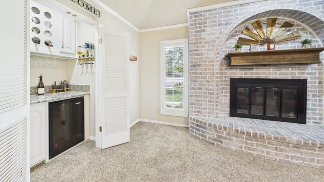 a view of a livingroom with an empty space and a fireplace