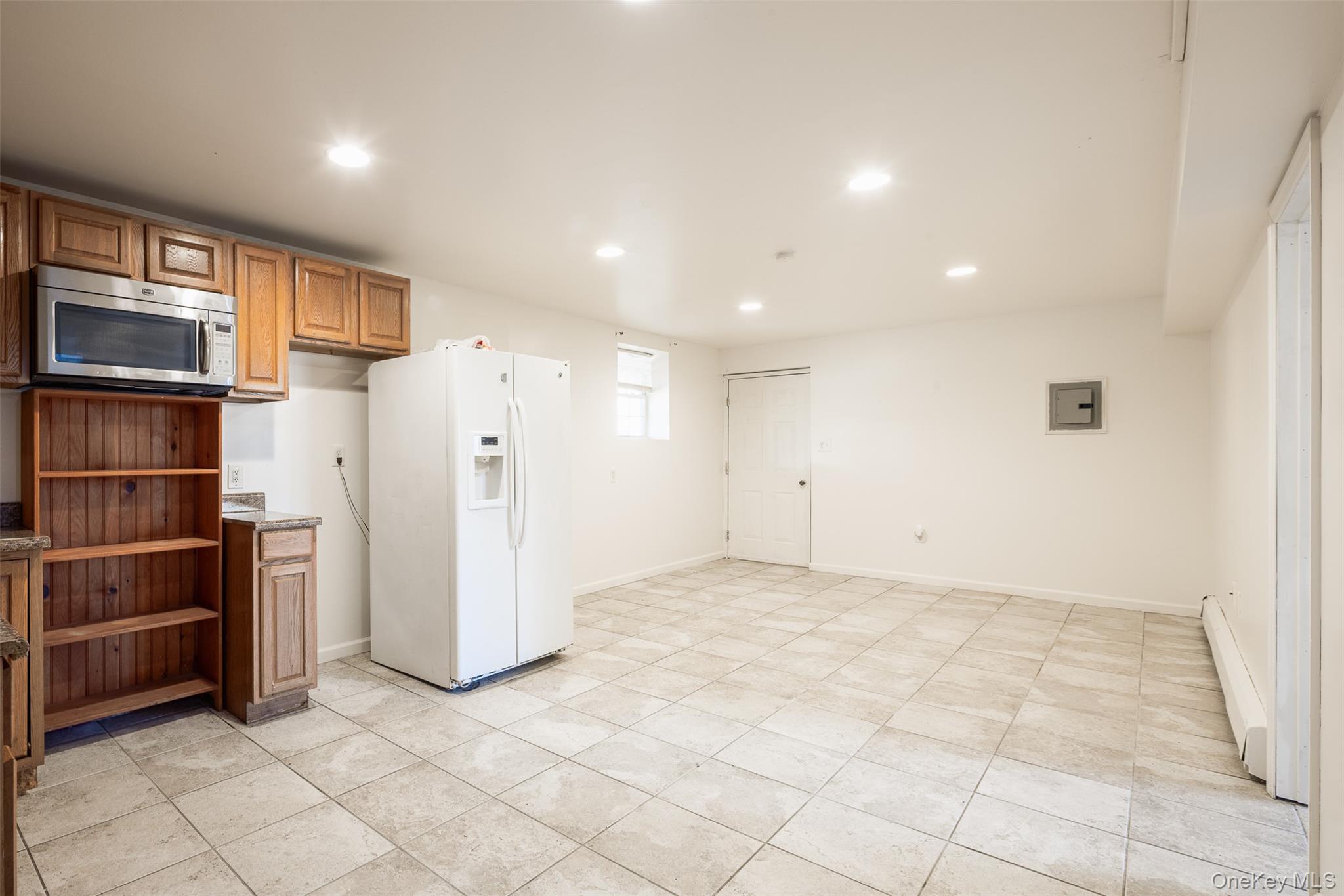 182 Whittier Drive Mastic Beach, NY 11951 - Photo 14 of 25 a view of kitchen with refrigerator and cabinets