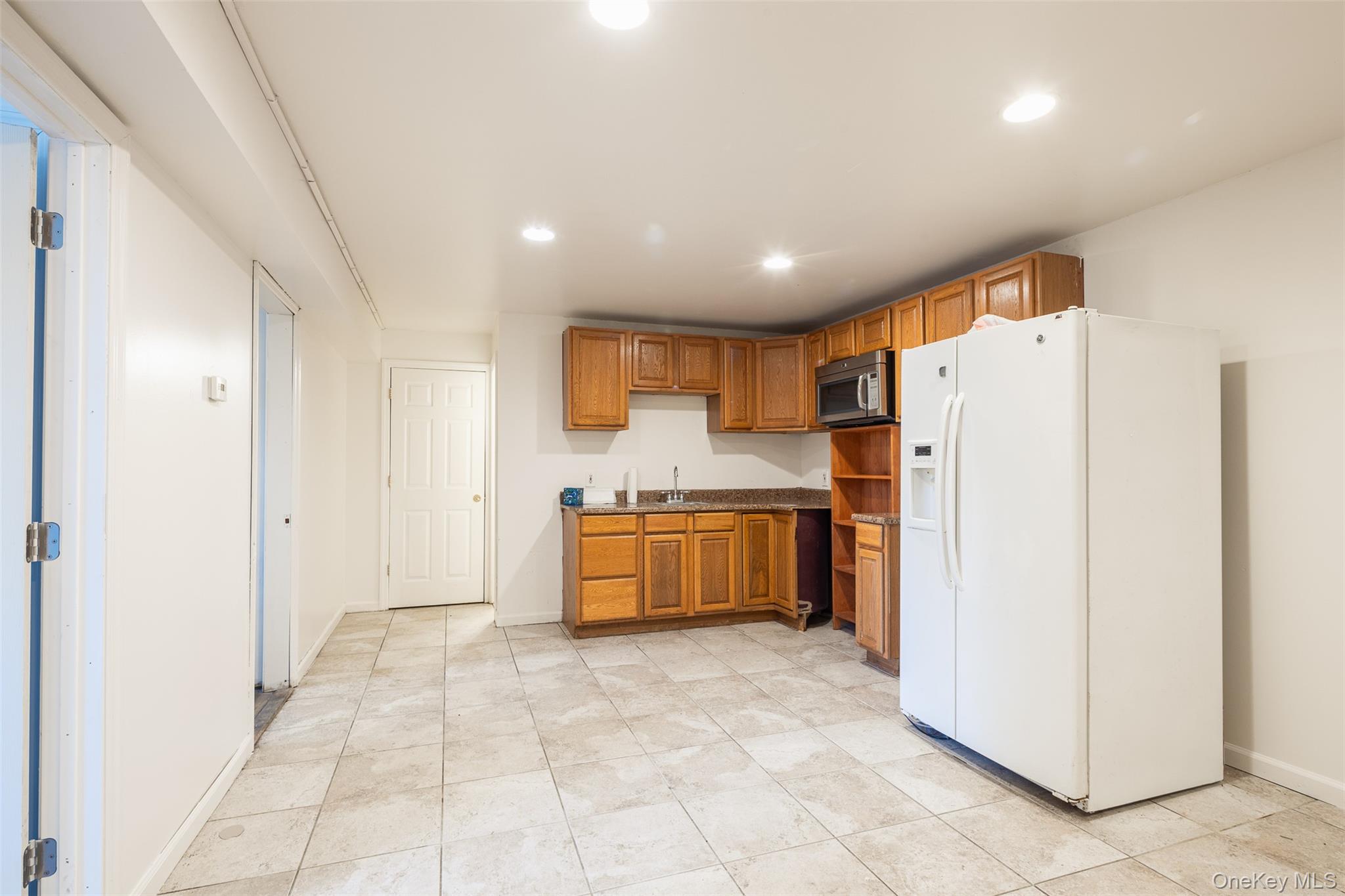 182 Whittier Drive Mastic Beach, NY 11951 - Photo 15 of 25 a kitchen with a refrigerator and a stove