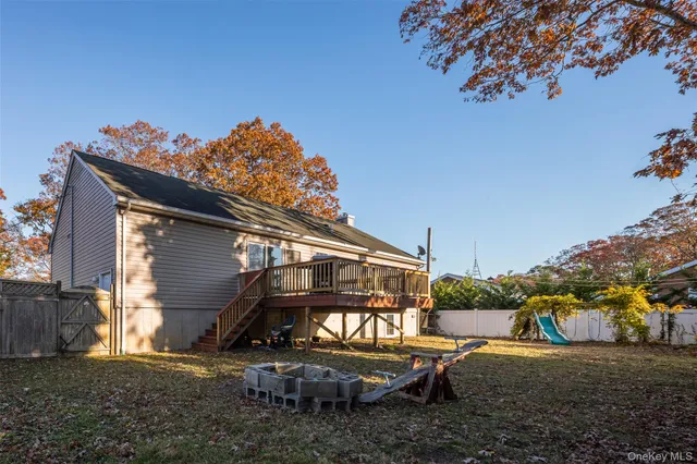 a view of backyard with deck and outdoor seating