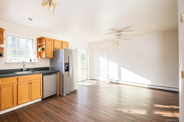 a view of a kitchen with a sink wooden floor and a window
