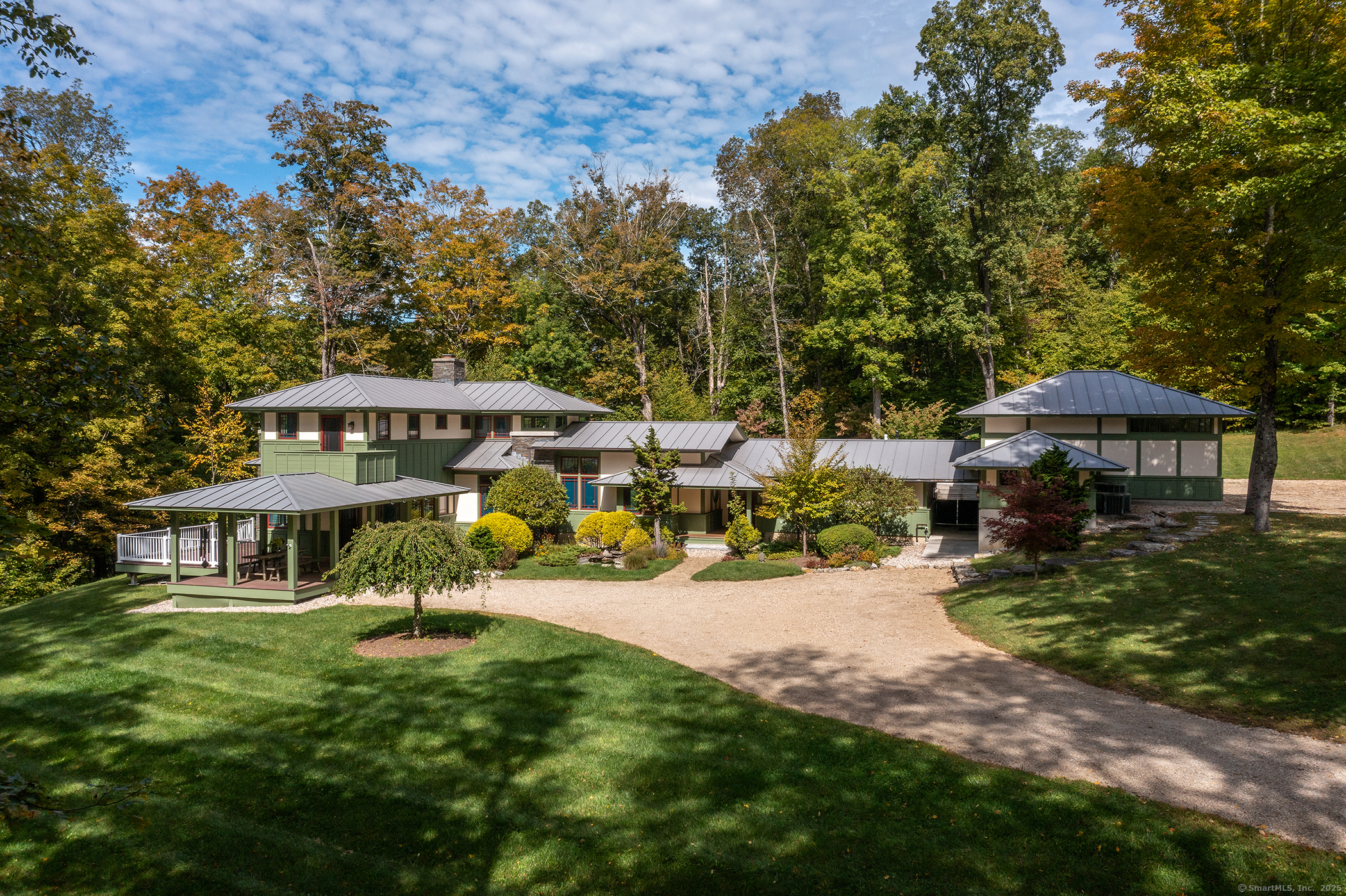 a view of a house with backyard and sitting area