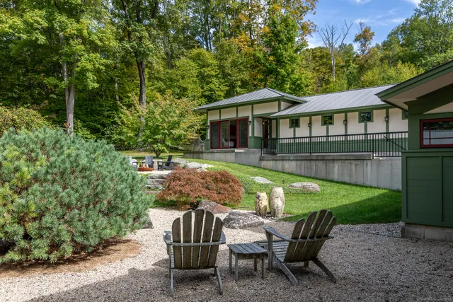 a front view of a house with garden and patio