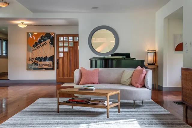 a living room with a couch and a potted plant