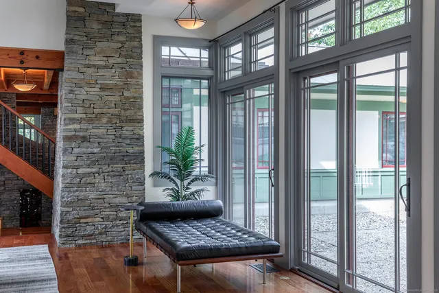 a living room with furniture and a floor to ceiling window