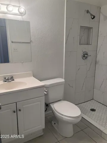 a white toilet sitting next to a bathroom sink