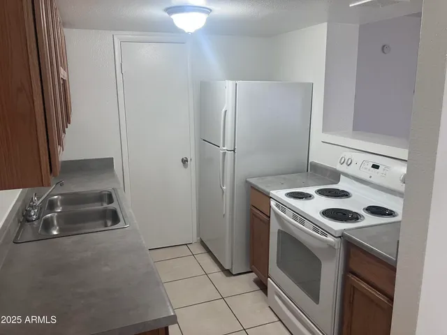 a kitchen with a stove and a refrigerator
