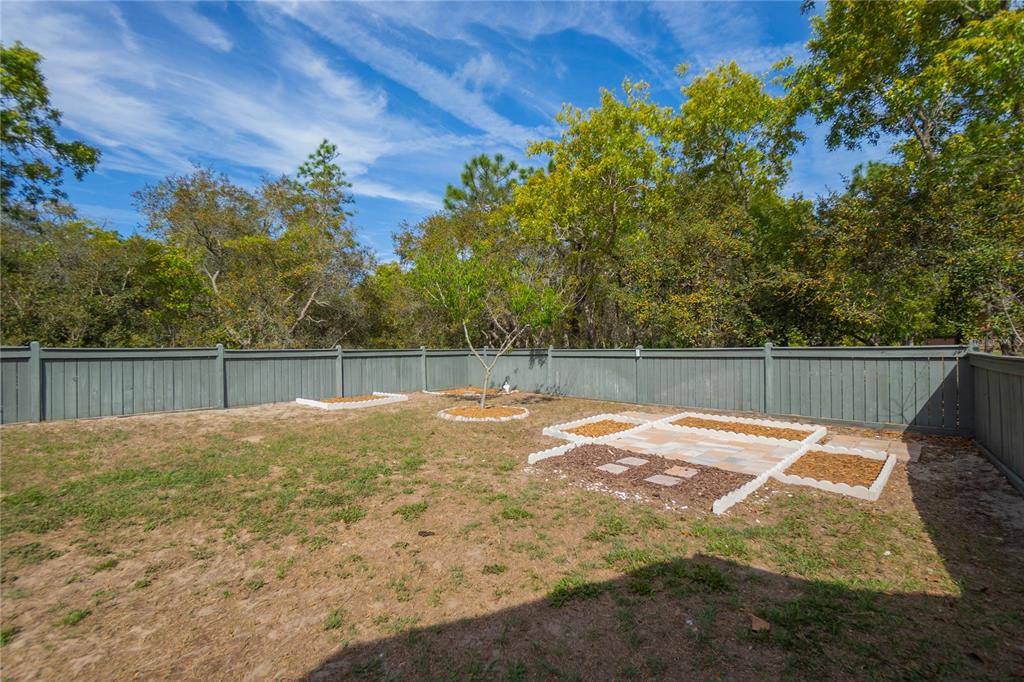 5466 West Tortuga Loop Lecanto, FL 34461 - Photo 39 of 41 a backyard of a house with table and chairs