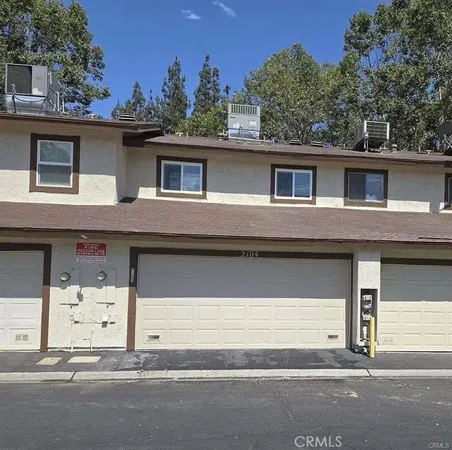 a house that has a tree in front of it