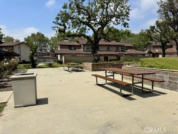 a view of a terrace with a bench and trees
