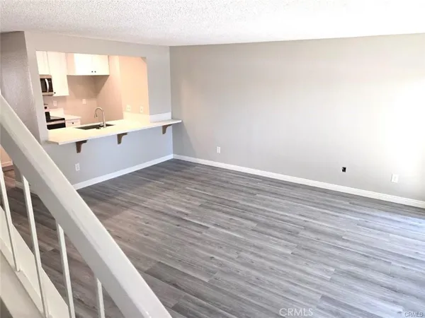a view of kitchen with wooden floor and electronic appliances