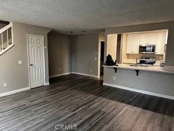 a view of a kitchen with a sink wooden floor and a window