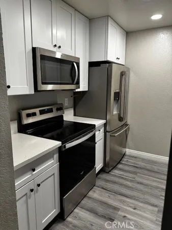 a kitchen with a refrigerator stove and microwave