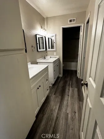 a bathroom with a sink a toilet and mirror