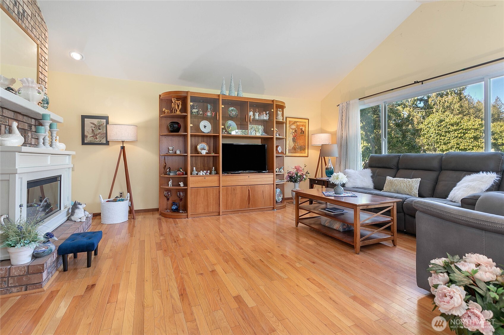 12544 Eagle Drive Burlington, WA 98233 - Photo 7 of 34 a living room with furniture a fireplace and a flat screen tv