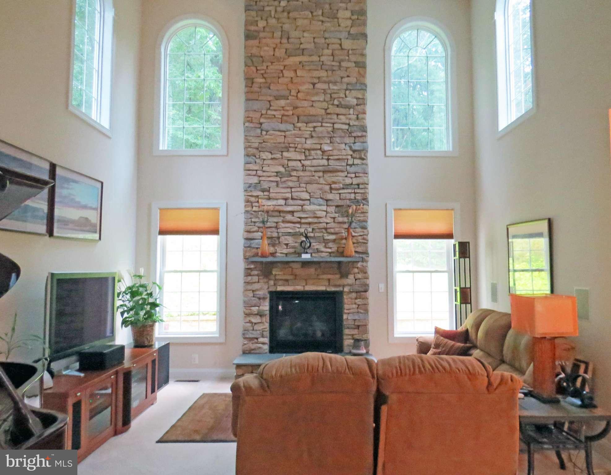 7650 Talbot Run Road Mount Airy, MD 21771 - Photo 3 of 15 a living room with furniture a fireplace and a large window