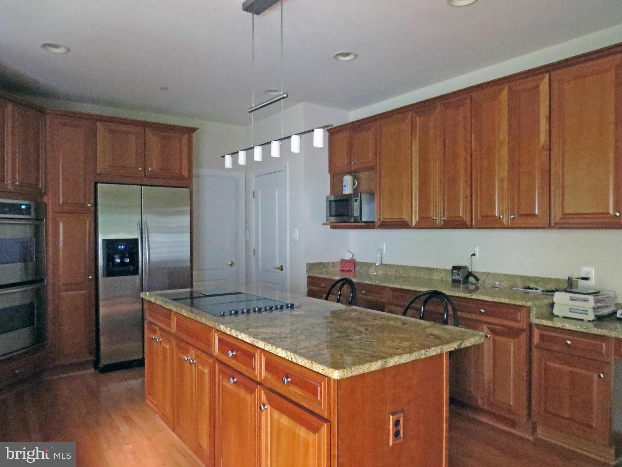 7650 Talbot Run Road Mount Airy, MD 21771 - Photo 6 of 15 a kitchen with stainless steel appliances granite countertop a sink a refrigerator and a stove