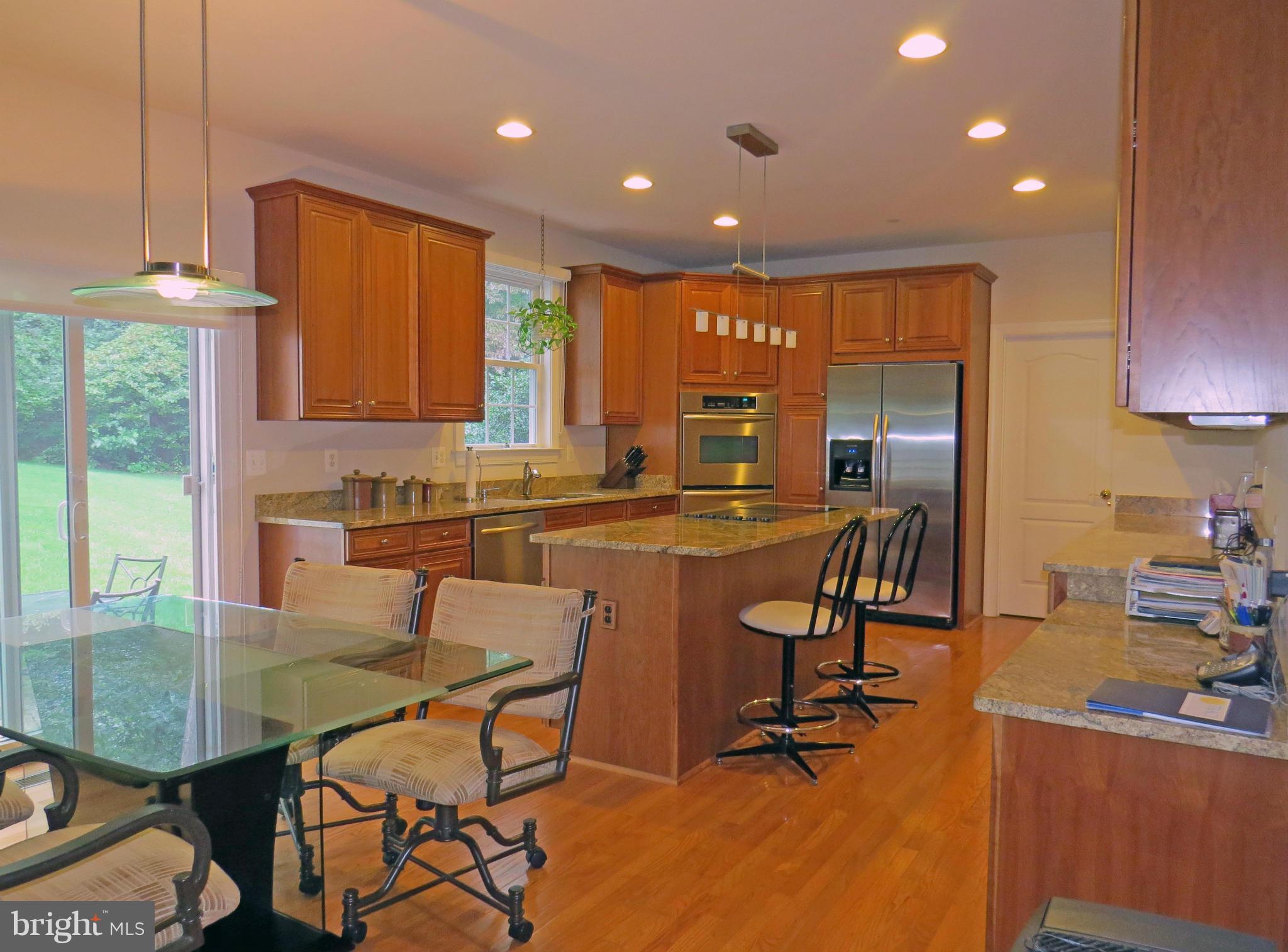 7650 Talbot Run Road Mount Airy, MD 21771 - Photo 7 of 15 a kitchen with a table chairs refrigerator and cabinets
