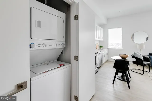 a view of washer and dryer with bathroom sink