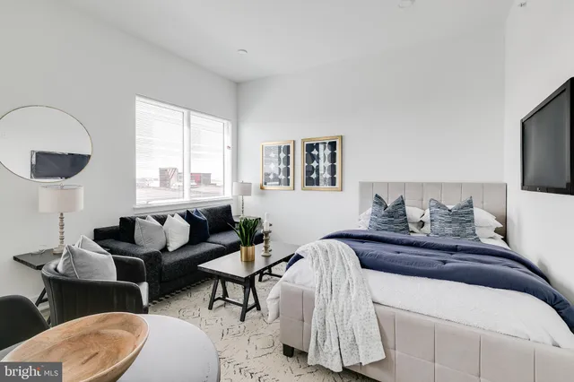 a bedroom with a bed and a couch