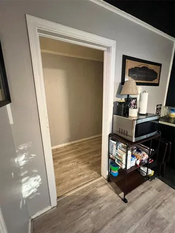a view of a hallway with workspace and a mirror