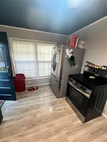 a kitchen with stove and refrigerator