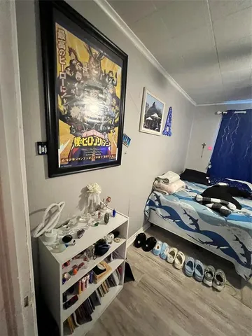 a bedroom with bed and a chandelier