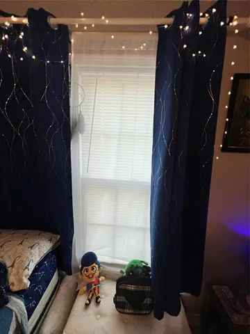 a view of a hallway with wooden floor and a bathroom