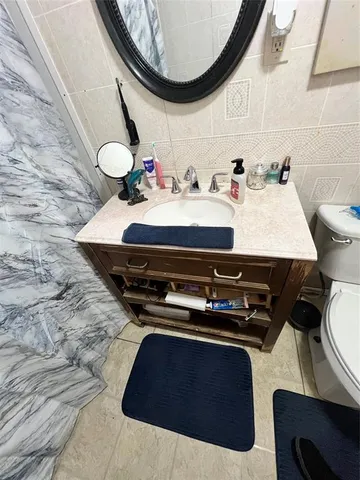 a bedroom with a bed and large mirror