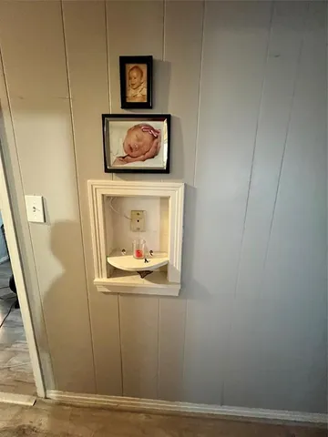 a bedroom with a bed mirror and a window