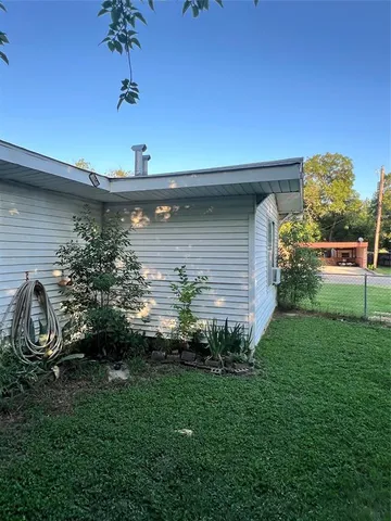 a view of a backyard with large trees