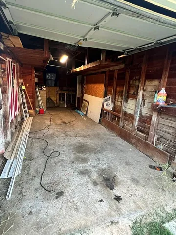 a view of a green field with wooden fence