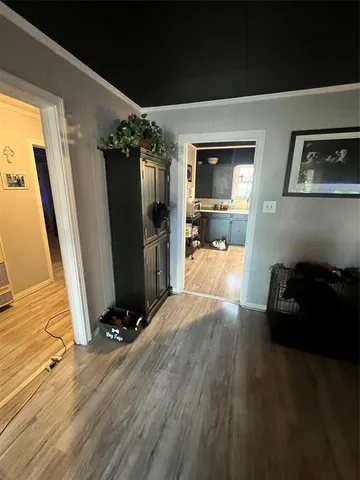 a living room with a large mirror next to a window