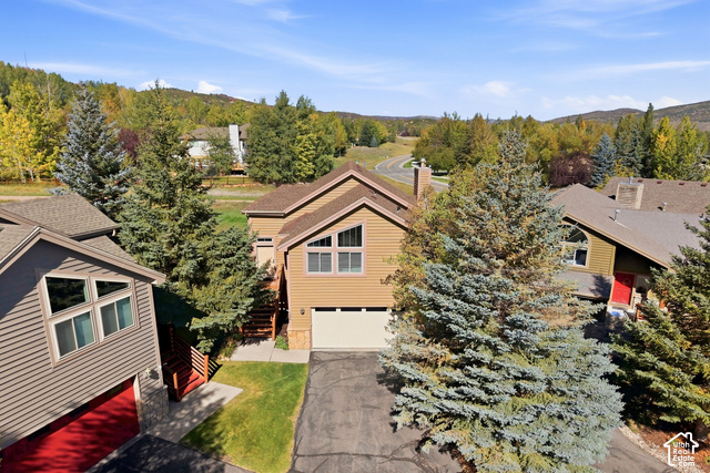 7396 Brook Hollow Loop Road Park City, UT 84098 - Photo 41 of 60 Multi-story residence featuring horizontal siding, an attached garage, and a peaked roofline