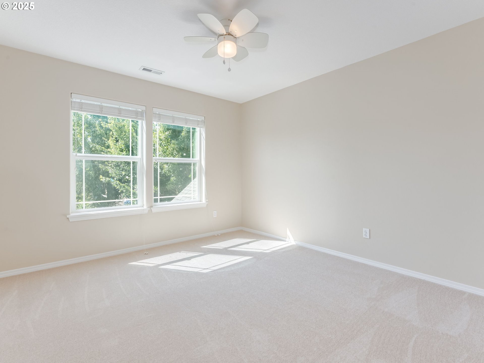 5641 Southeast Chase Loop Gresham, OR 97080 - Photo 21 of 39 an empty room with a window and a fan