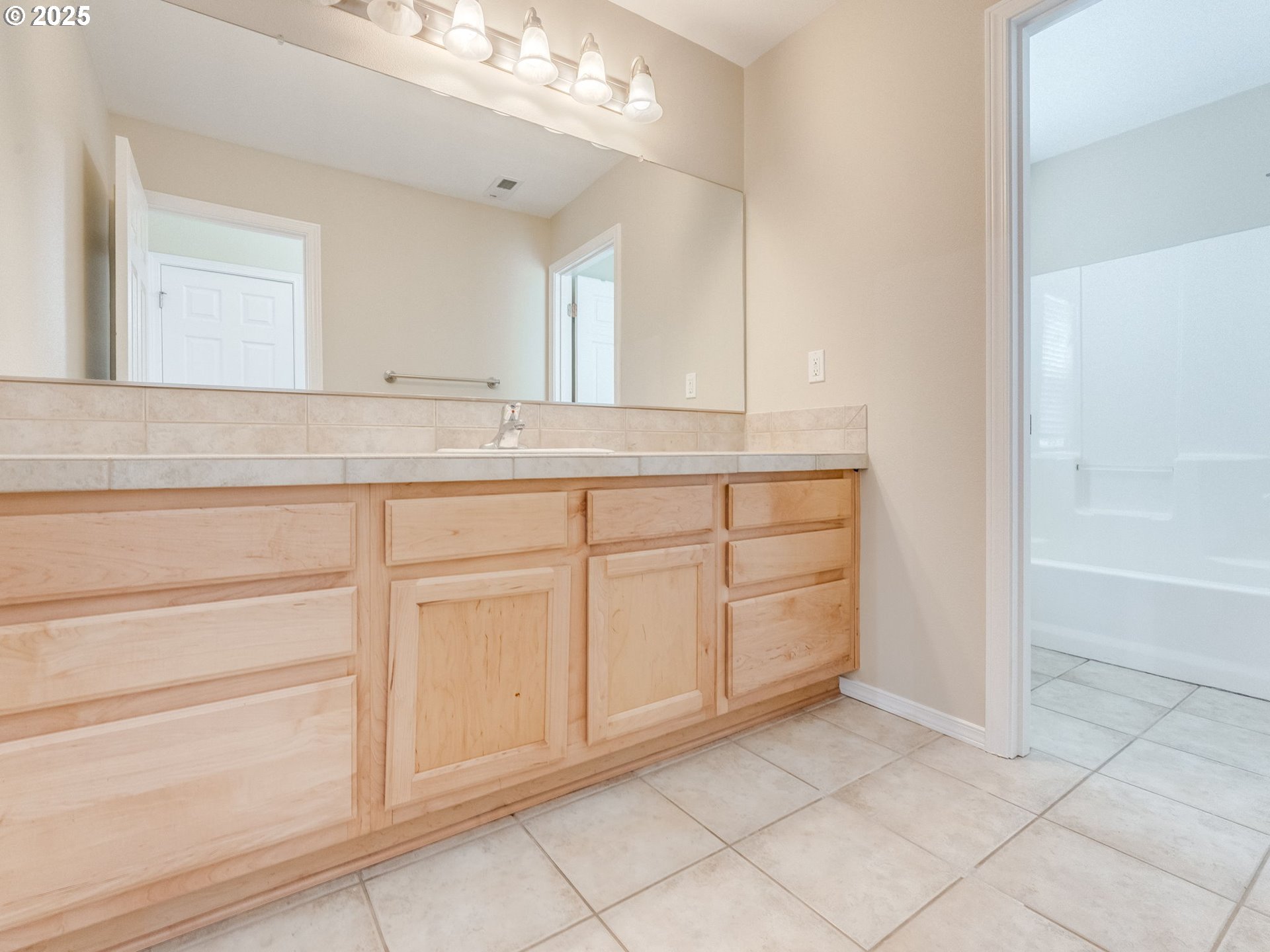 5641 Southeast Chase Loop Gresham, OR 97080 - Photo 25 of 39 a bathroom with a sink a vanity and a mirror