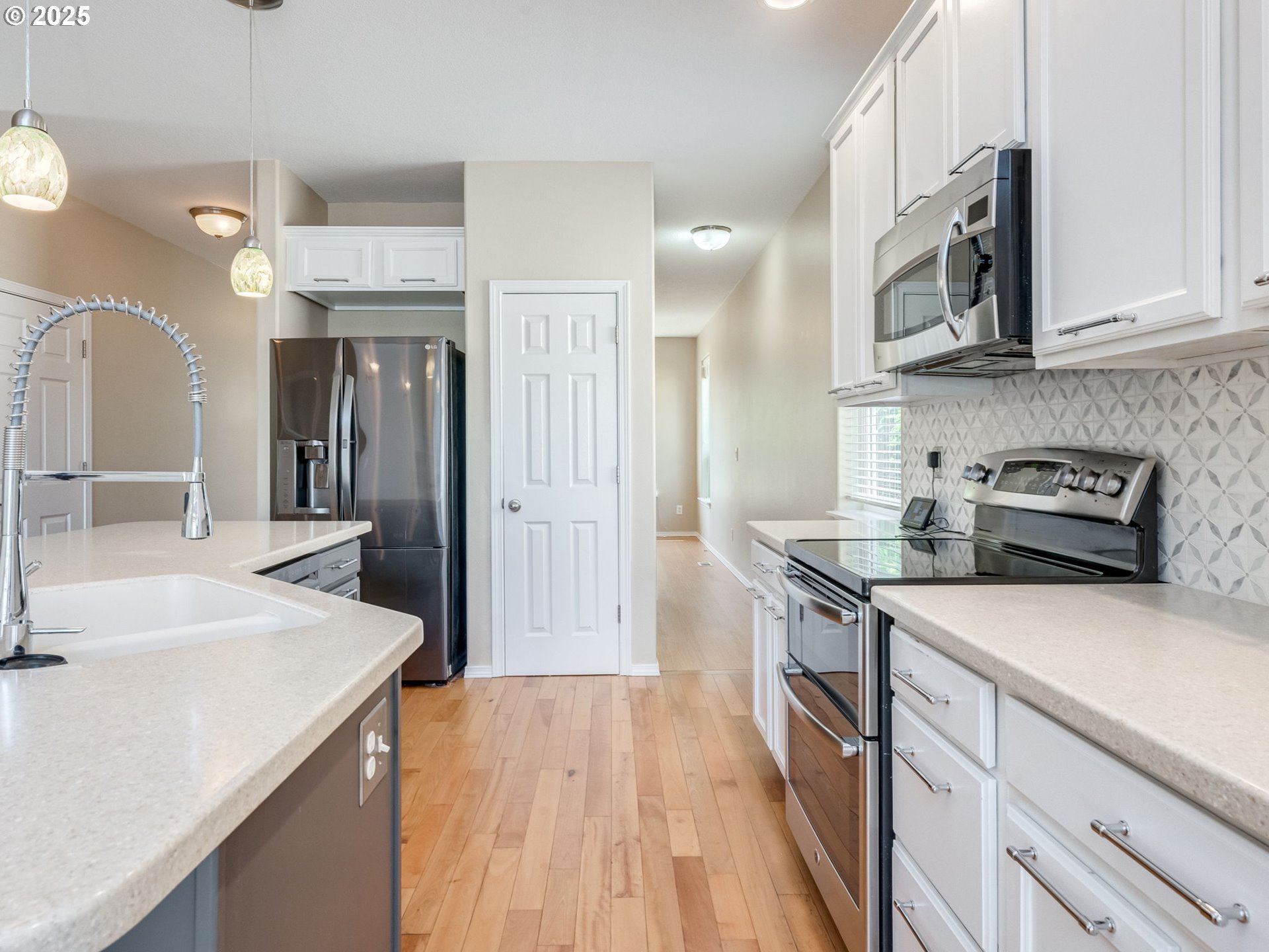 5641 Southeast Chase Loop Gresham, OR 97080 - Photo 6 of 39 a kitchen that has a sink a stove and a wooden floors
